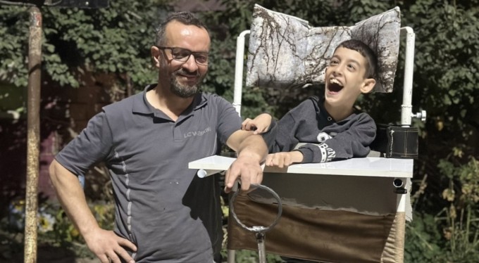 Fedak&acirc;r baba, yaptığı engelli ayakta durma sehpasıyla oğlunu mahalle mahalle gezdiriyor